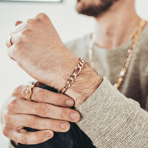 Gold Figaro bracelet featuring alternating pattern links, known for its timeless and sophisticated design-1