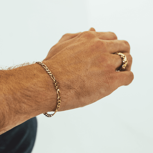Gold Figaro bracelet featuring alternating pattern links, known for its timeless and sophisticated design-3