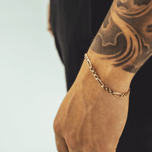 Gold Figaro bracelet featuring alternating pattern links, known for its timeless and sophisticated design-4