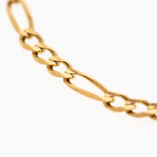 Gold Figaro bracelet featuring alternating pattern links, known for its timeless and sophisticated design-5