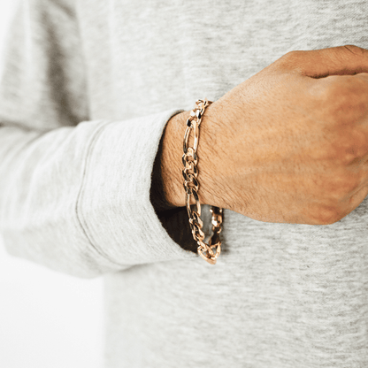Gold Figaro bracelet featuring alternating pattern links, known for its timeless and sophisticated design